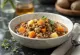 Soupe Minestrone servie avec lentilles, beaucoup de légumes et pâtes dans une assiette creuse